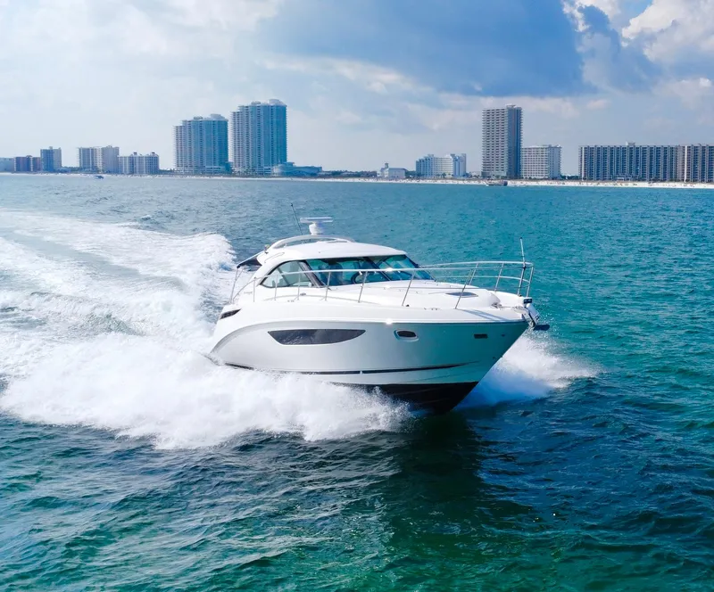 The Image of Sea Ray 410 Sundancer 2013 cruising on ocean near city skyline. - 0