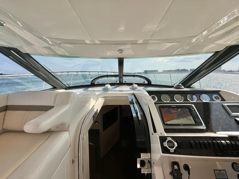 Slide: The Image of Interior view of 2013 Sea Ray 410 Sundancer yacht cockpit with navigation system. - 15