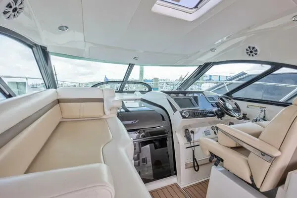 Slide: The Image of Luxurious interior of 2013 Sea Ray 410 Sundancer yacht with modern helm and seating. - 16
