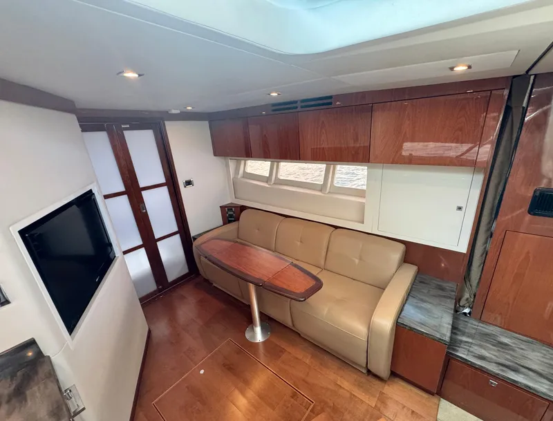 Slide: The Image of Luxurious interior of 2013 Sea Ray 410 Sundancer yacht with leather seating and wood finishes. - 18