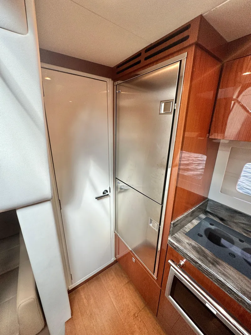Slide: The Image of 2013 Sea Ray 410 Sundancer yacht interior with modern kitchen appliances. - 25