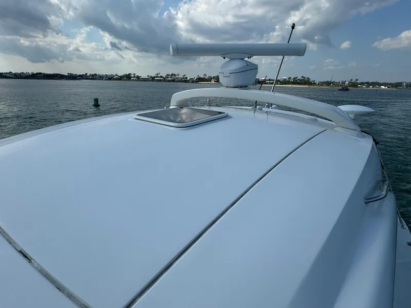 Slide: The Image of 2013 Sea Ray 410 Sundancer yacht on calm waters under cloudy sky. - 33