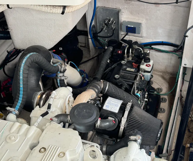 Slide: The Image of Engine compartment of 2013 Sea Ray 410 Sundancer boat, showcasing mechanical components. - 36