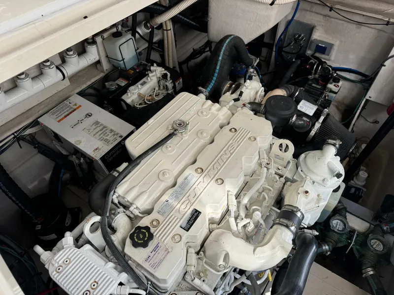 Slide: The Image of Engine compartment of 2013 Sea Ray 410 Sundancer boat, showcasing detailed machinery. - 38