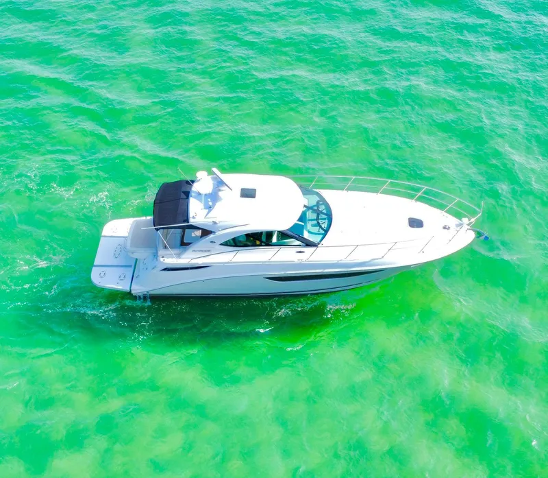 Slide: The Image of Aerial view of 2013 Sea Ray 410 Sundancer yacht on vibrant green water. - 4