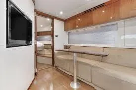 Slide: The Image of Luxurious interior of 2013 Sea Ray 410 Sundancer yacht with modern seating and TV. - 42