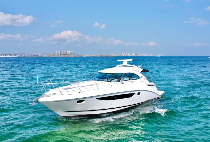 Slide: The Image of 2013 Sea Ray 410 Sundancer yacht cruising on clear blue ocean waters. - 5