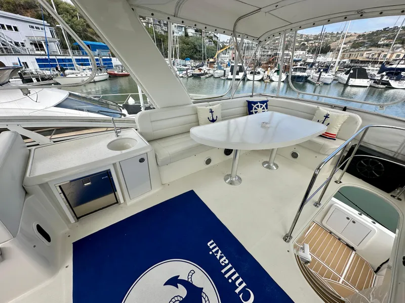 Slide: The Image of 2008 Carver 43 Super Sport yacht with spacious seating and marina view. - 11