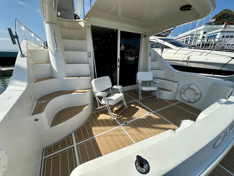 Slide: The Image of 2008 Carver 43 Super Sport yacht deck with seating and stairs. - 15
