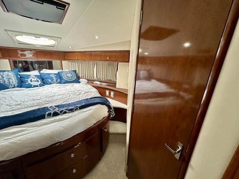 Slide: The Image of Luxurious bedroom interior of 2008 Carver 43 Super Sport yacht with elegant wood finishes. - 26