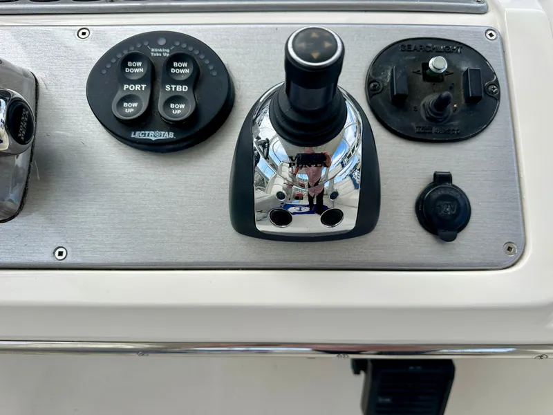 Slide: The Image of Control panel of a 2008 Carver 43 Super Sport boat with joystick and buttons. - 9