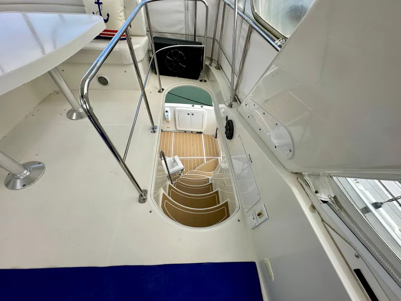 Slide: The Image of 2008 Carver 43 Super Sport yacht interior with staircase and seating area. - 12