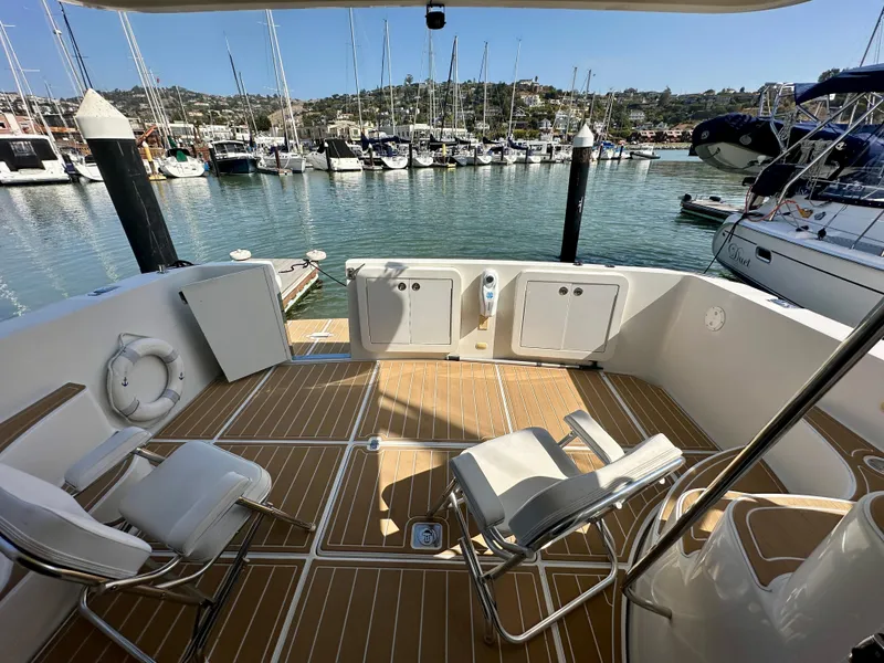 Slide: The Image of 2008 Carver 43 Super Sport yacht deck with chairs, docked at marina. - 17