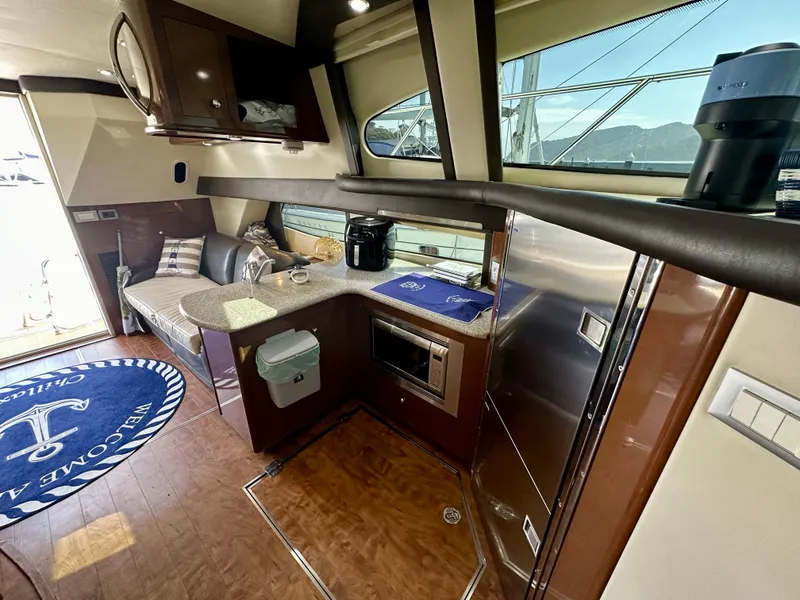 Slide: The Image of Interior of 2008 Carver 43 Super Sport yacht with modern kitchen and seating area. - 22
