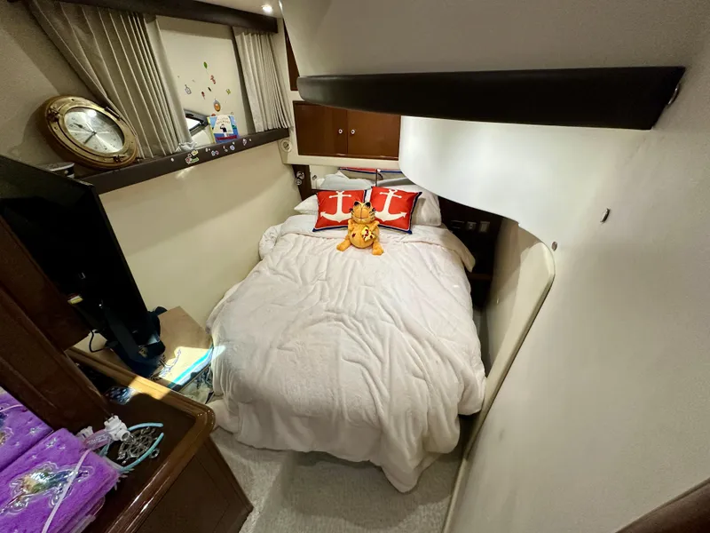 Slide: The Image of Cozy bedroom in 2008 Carver 43 Super Sport yacht with plush bedding and decorative pillows. - 31