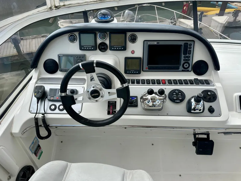 Slide: The Image of Helm of 2008 Carver 43 Super Sport yacht with steering wheel and navigation controls. - 7