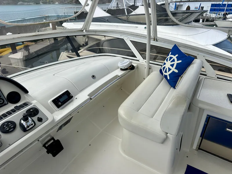 Slide: The Image of 2008 Carver 43 Super Sport yacht cockpit with white seating and nautical-themed decor. - 8