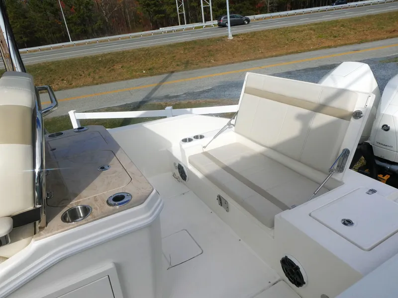 Slide: The Image of 2024 Boston Whaler 280 Dauntless boat interior with seating and console. - 11