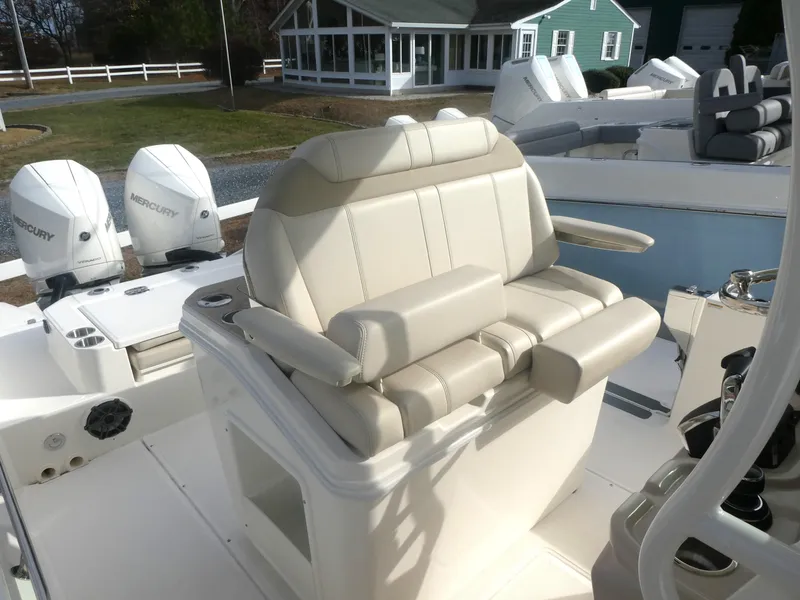 Slide: The Image of 2024 Boston Whaler 280 Dauntless boat interior with comfortable seating and Mercury engines. - 12