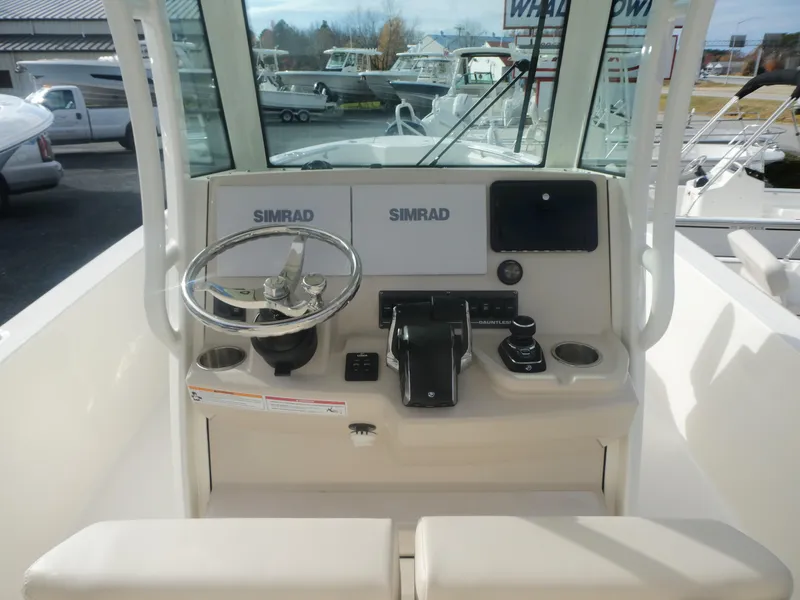 Slide: The Image of 2024 Boston Whaler 280 Dauntless helm with Simrad electronics and steering wheel. - 5