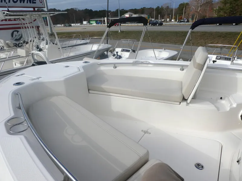 Slide: The Image of 2024 Boston Whaler 280 Dauntless boat interior with white seating and cup holders. - 6