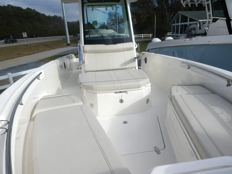 Slide: The Image of 2024 Boston Whaler 280 Dauntless boat interior with seating and storage. - 8