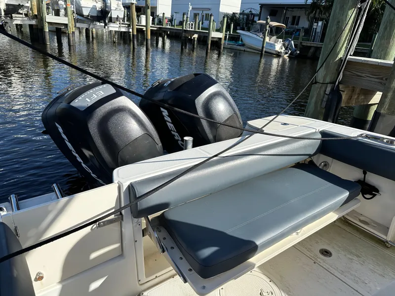 Slide: The Image of 2012 Boston Whaler 220 Outrage with dual engines docked at marina. - 3