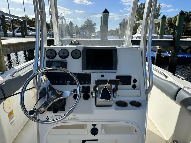 Slide: The Image of Boston Whaler 220 Outrage 2012 boat console with steering wheel and navigation controls. - 4