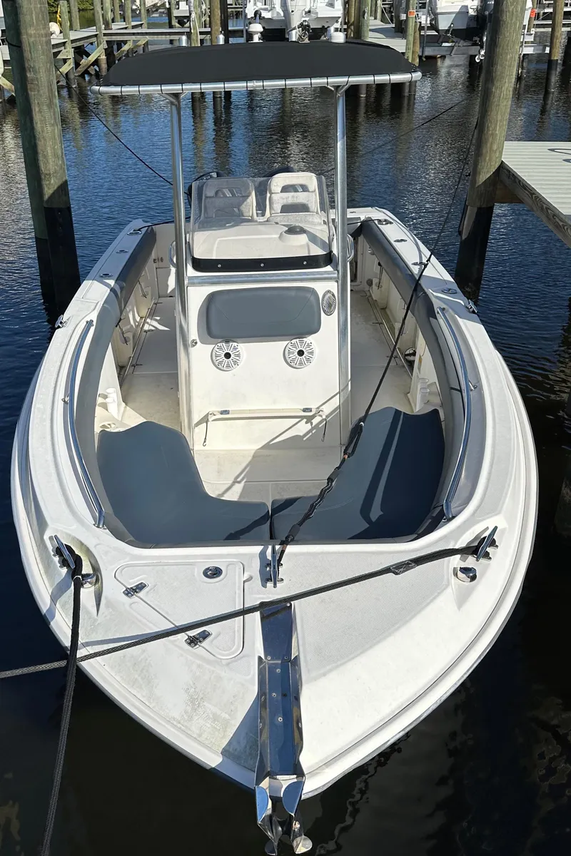 Slide: The Image of 2012 Boston Whaler 220 Outrage boat docked in marina. - 5