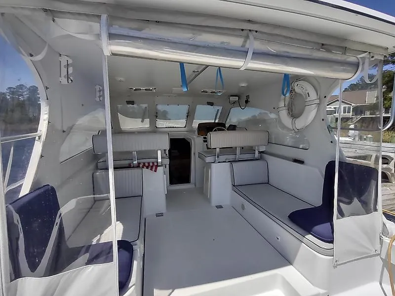 Slide: The Image of 2001 Mainship Pilot 34 Sedan interior with seating and navigation area. - 3