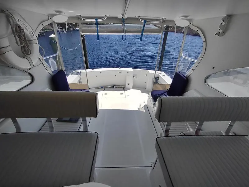 Slide: The Image of 2001 Mainship Pilot 34 Sedan interior with seating, overlooking water. - 6