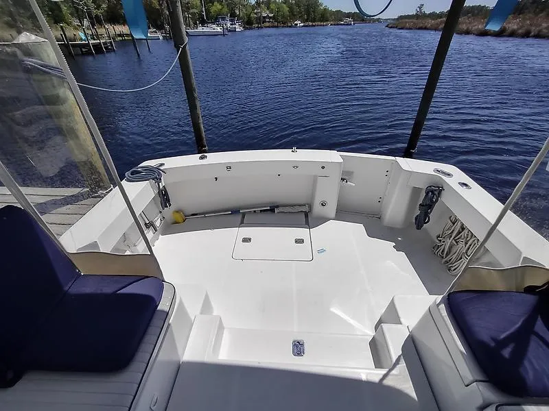 Slide: The Image of 2001 Mainship Pilot 34 Sedan boat deck with seating, overlooking calm waters. - 7