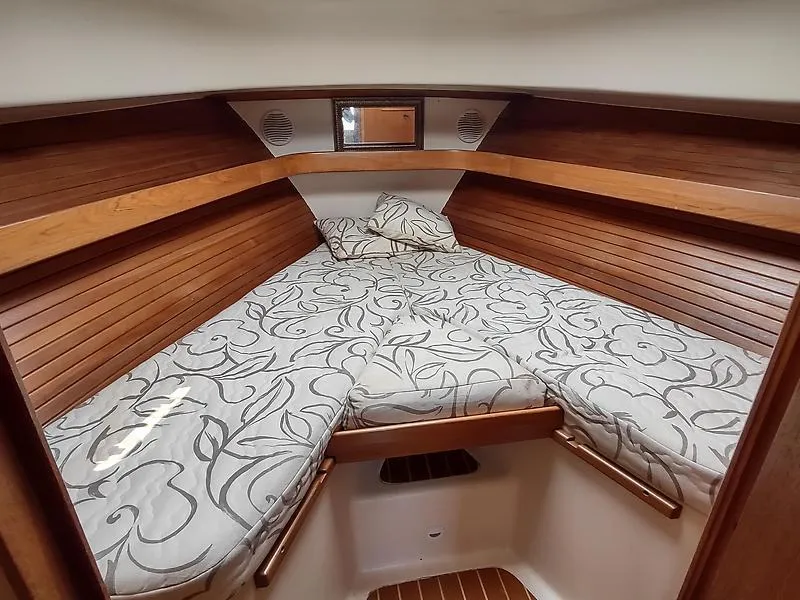 Slide: The Image of 2001 Mainship Pilot 34 Sedan cabin with cozy bed and wooden interior. - 9