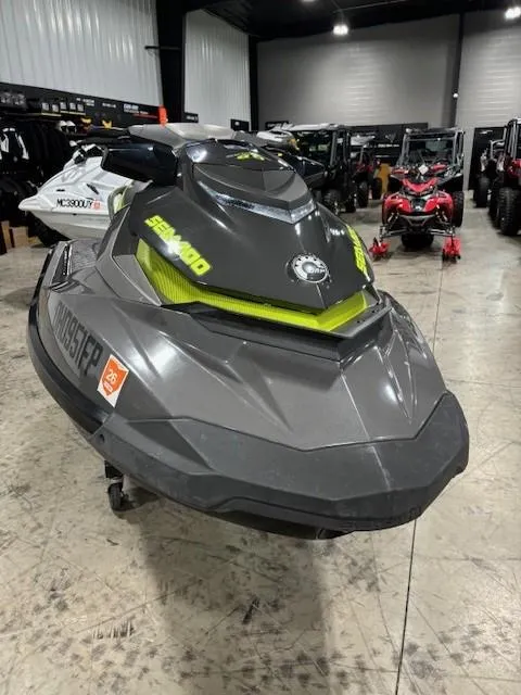 Slide: The Image of 2015 Sea-Doo GTI Limited 155 jet ski in showroom, black and green design. - 10