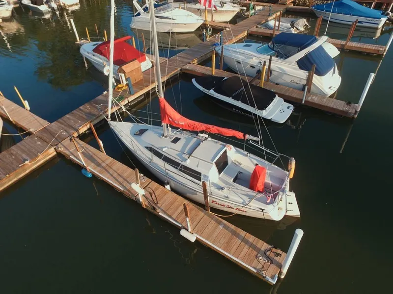 Slide: The Image of 1988 O'Day 27' LE sailboat docked at marina with other boats. - 1