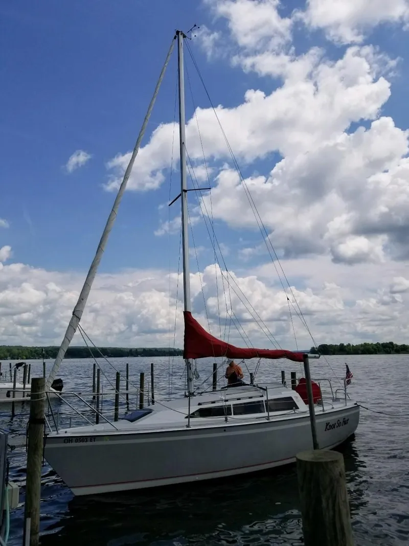 Slide: The Image of 1988 O'Day 27' LE sailboat docked under a partly cloudy sky. - 2