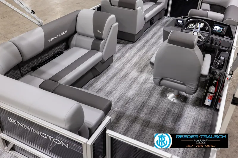Slide: The Image of 2025 Bennington 188 SLS pontoon boat interior with gray seating and modern dashboard. - 10