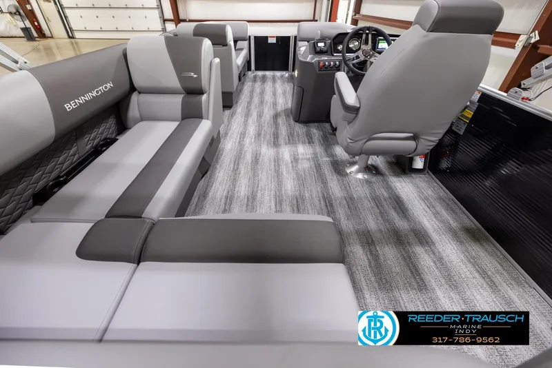 Slide: The Image of 2025 Bennington 188 SLS boat interior with gray seating and modern dashboard. - 14