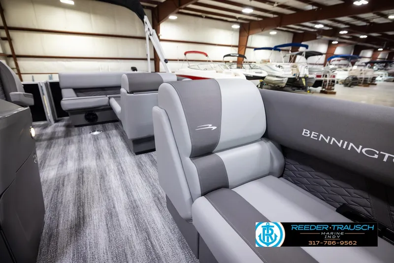 Slide: The Image of 2025 Bennington 188 SLS pontoon boat interior with gray seating in showroom. - 18