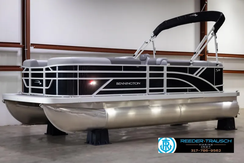 Slide: The Image of 2025 Bennington 188 SLS pontoon boat in showroom, featuring sleek design and modern amenities. - 2