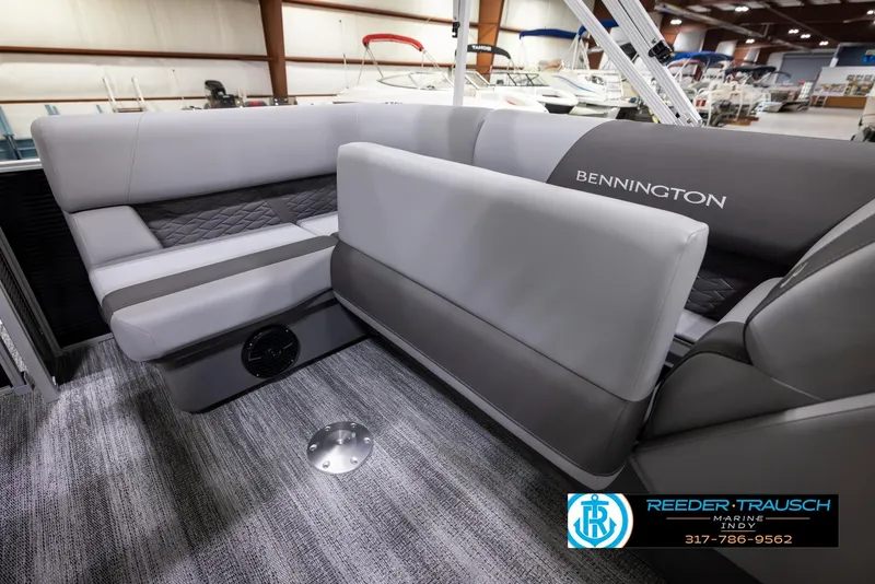 Slide: The Image of 2025 Bennington 188 SLS boat interior with gray seating and carpeted flooring. - 21