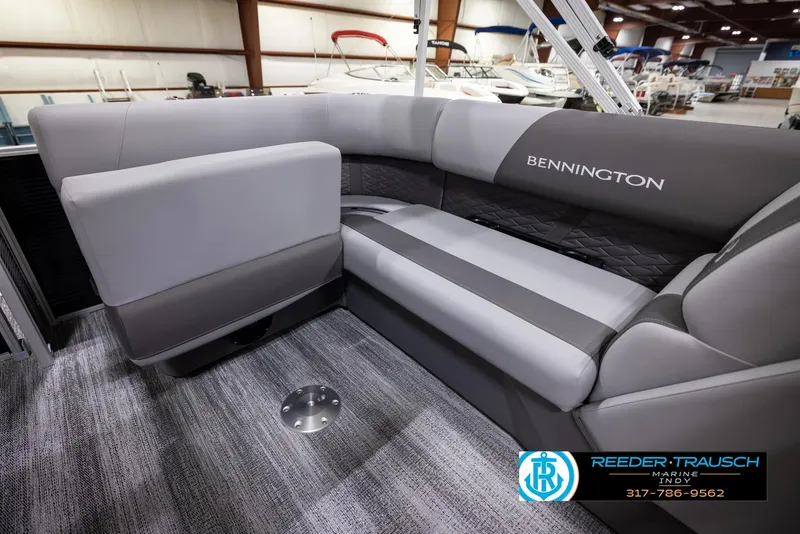 Slide: The Image of 2025 Bennington 188 SLS boat interior with gray seating and carpeted flooring. - 22