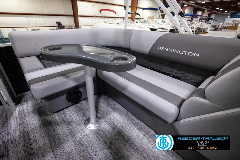 Slide: The Image of 2025 Bennington 188 SLS boat interior with gray seating and table. - 23