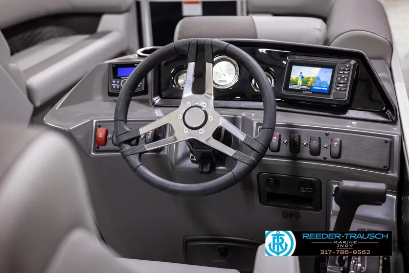 Slide: The Image of 2025 Bennington 188 SLS boat dashboard with steering wheel and modern controls. - 24