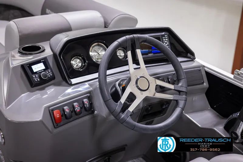 Slide: The Image of 2025 Bennington 188 SLS boat dashboard with steering wheel and control panel. - 25