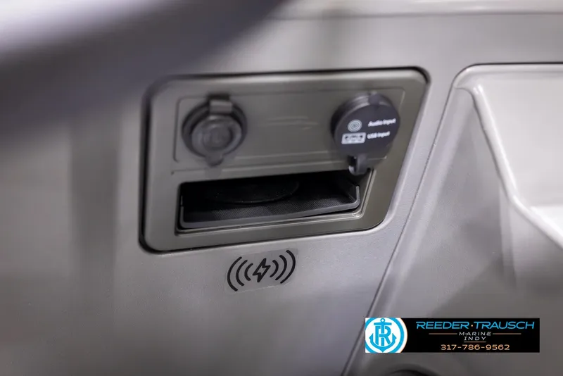 Slide: The Image of 2025 Bennington 188 SLS dashboard with USB port and wireless charging pad. - 32