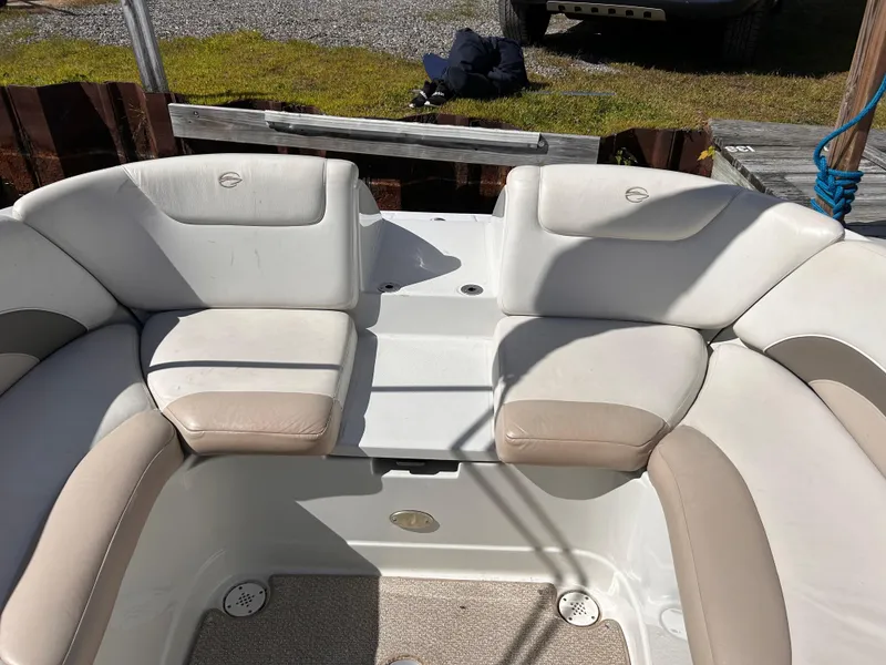 Slide: The Image of 2007 Crownline 255 CCR boat interior with beige and white seating. - 11
