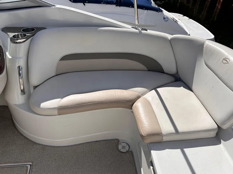 Slide: The Image of 2007 Crownline 255 CCR boat interior seating with beige and white upholstery. - 15
