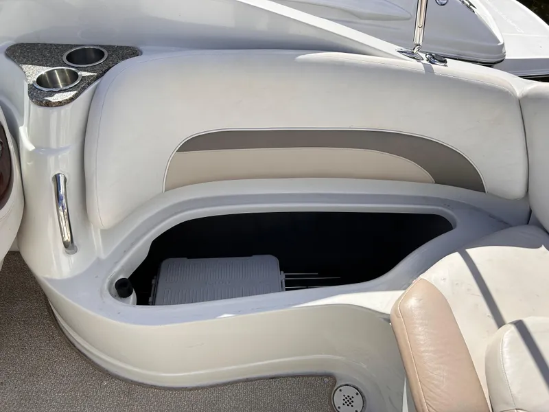 Slide: The Image of 2007 Crownline 255 CCR boat interior seating with storage compartment and cup holders. - 16