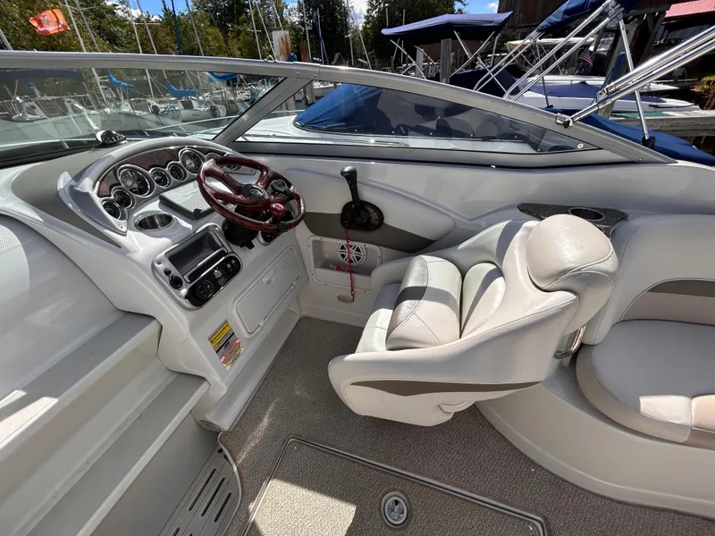 Slide: The Image of 2007 Crownline 255 CCR boat interior with steering wheel and seating. - 19